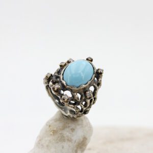 Silver and gold ring with turquoise stone and 8 grey diamonds