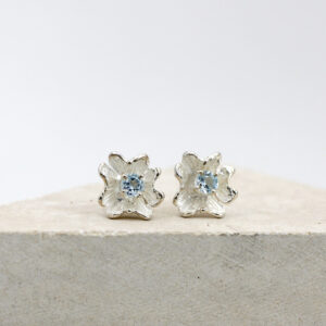 Silver flower-shaped earrings with blue Topaz